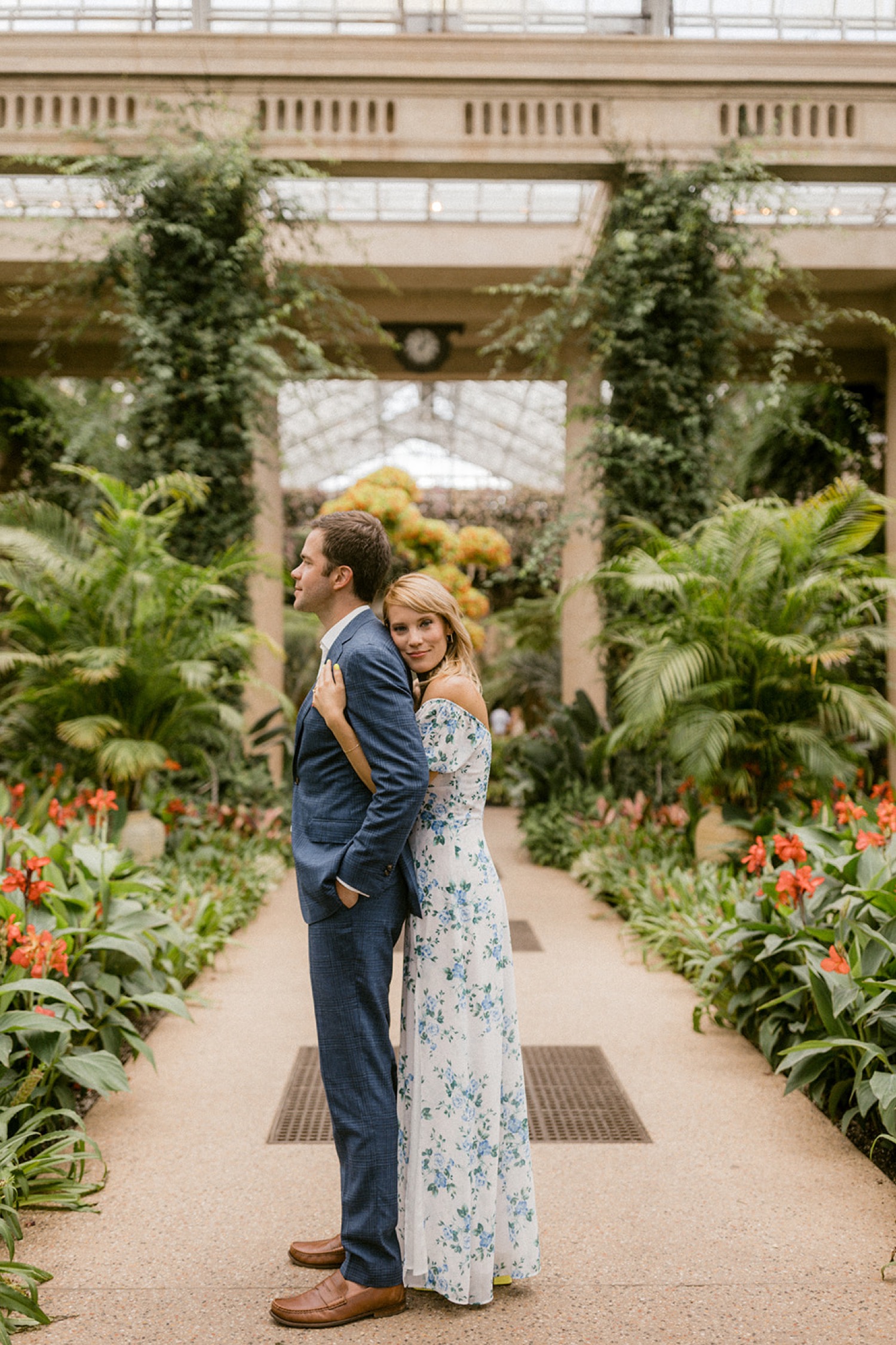 hugging from behind formal engagement session in greenhouse