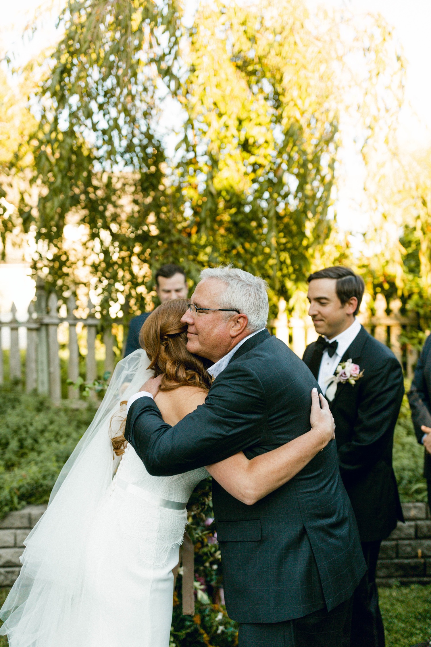 bride and father hugging backyard wedding ceremony