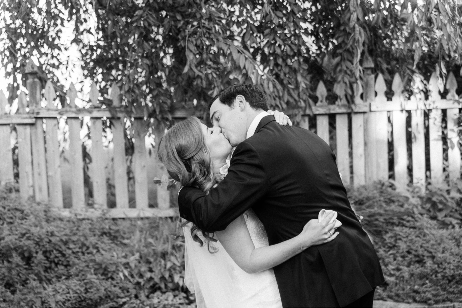bride and groom kissing backyard wedding ceremony