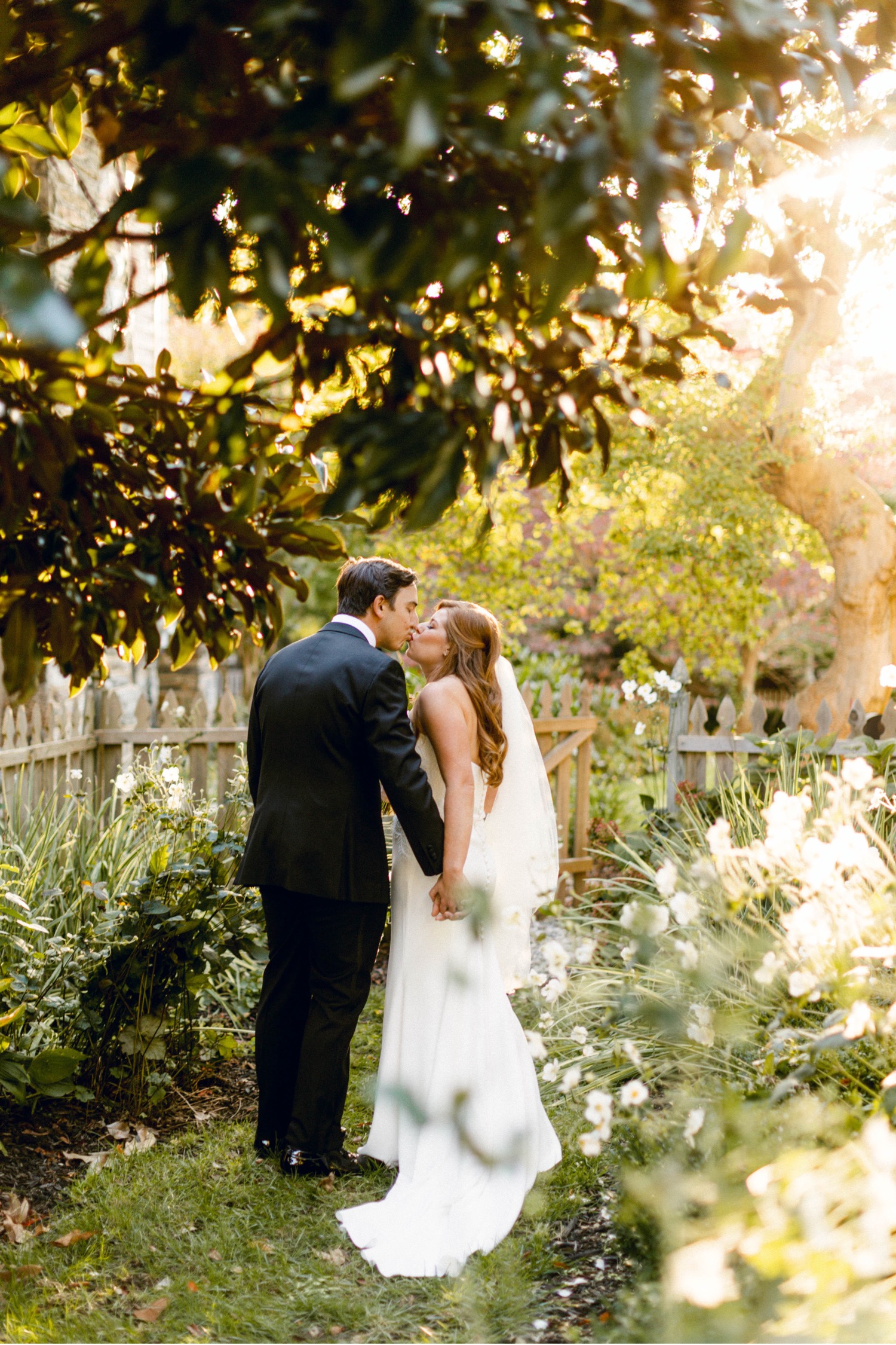 bride and groom kissing after wedding ceremony luxurious backyard wedding