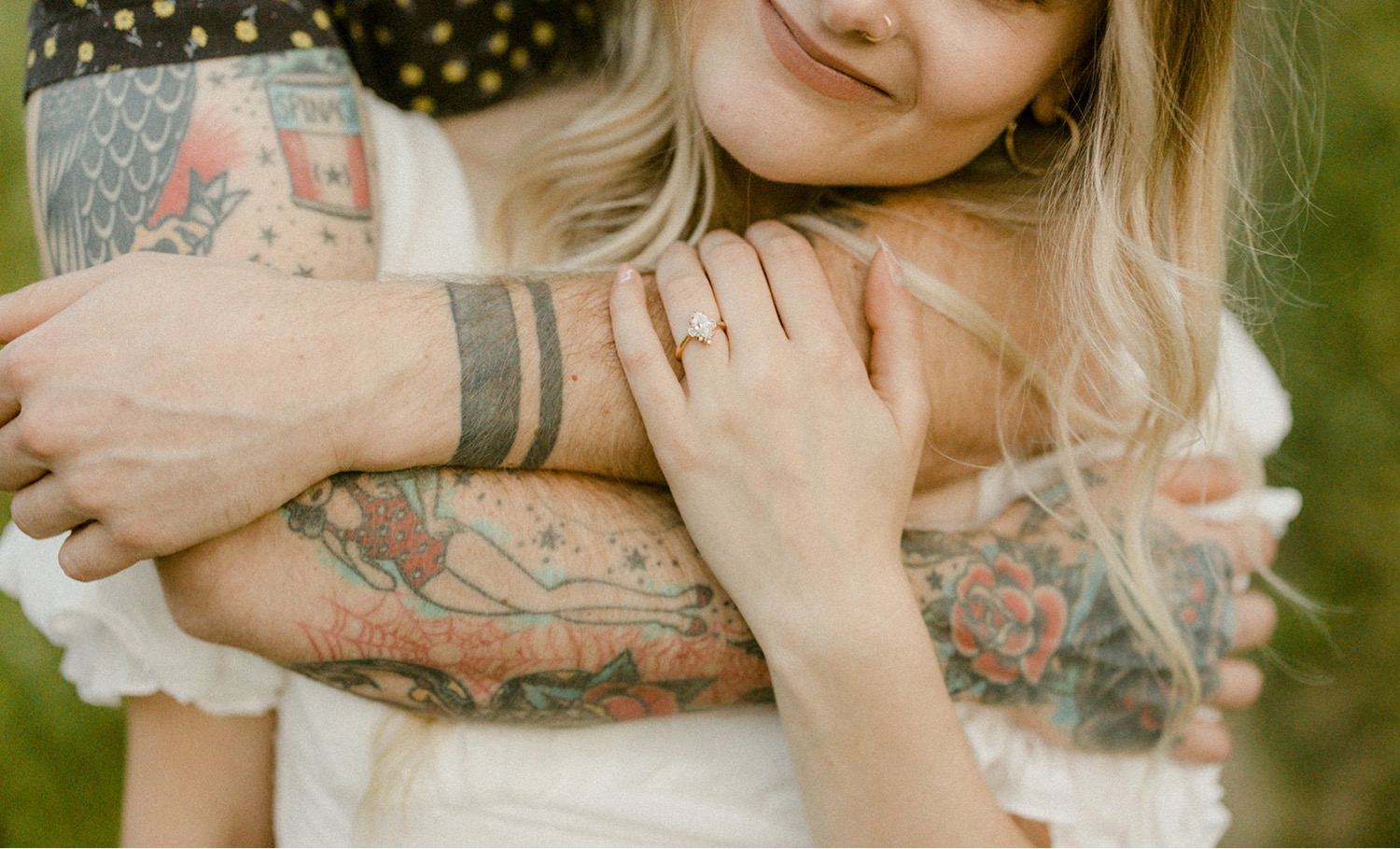 couple hugging tattoos engagement ring