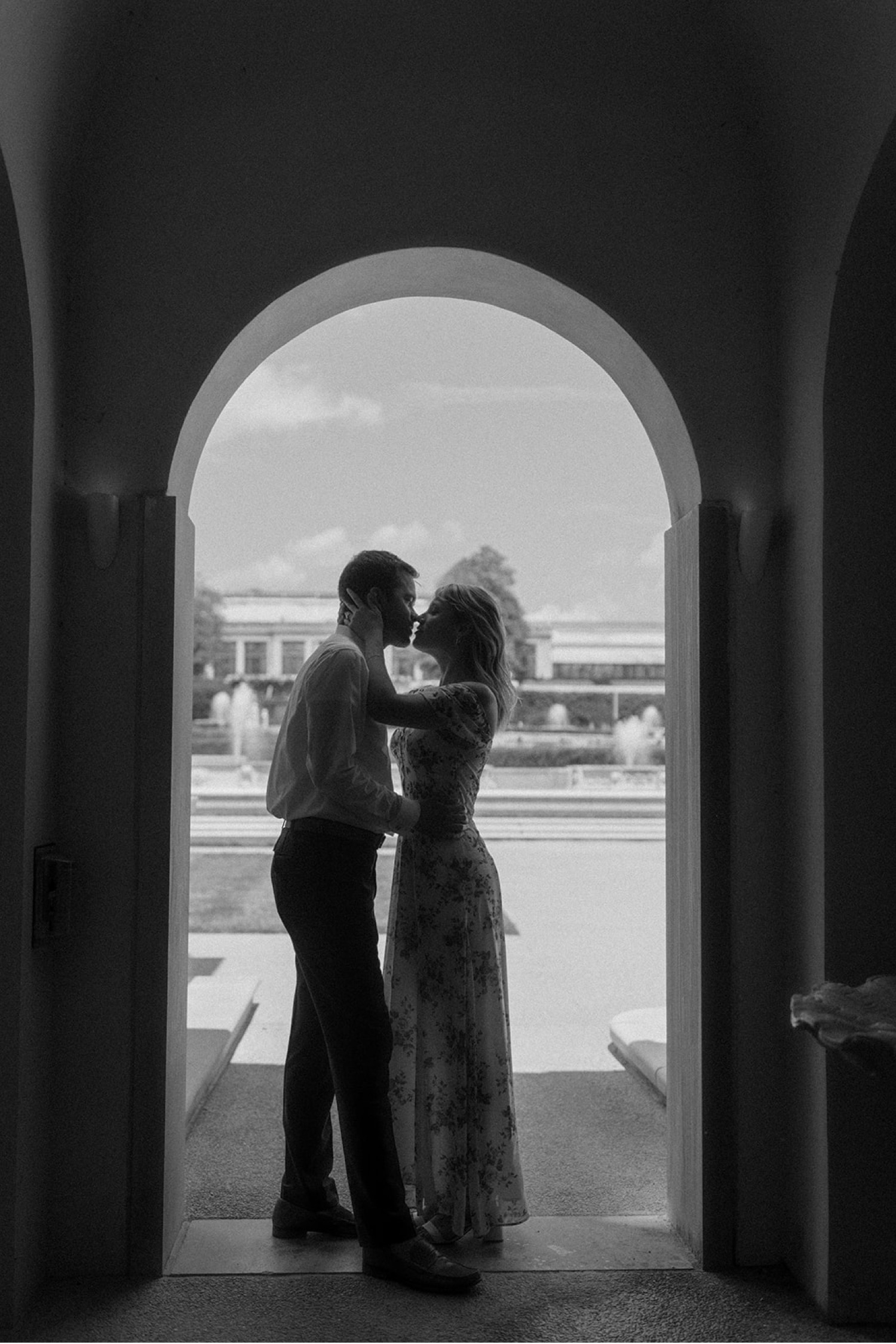 black and white kissing in doorway engagement session