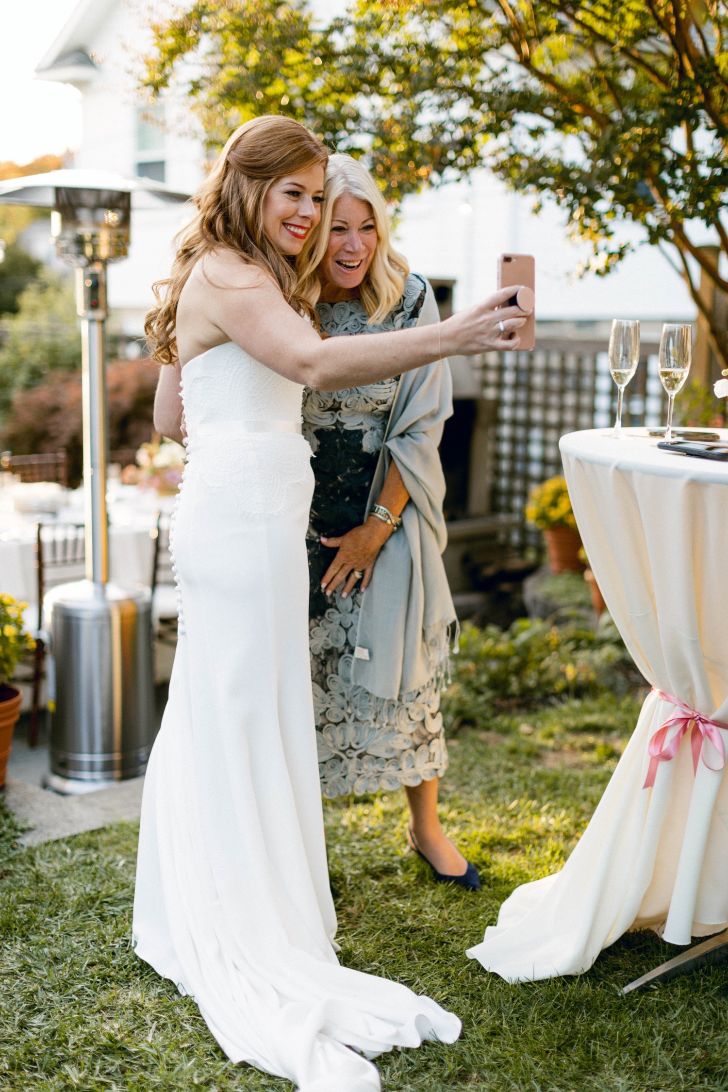 bride taking selfie with mom