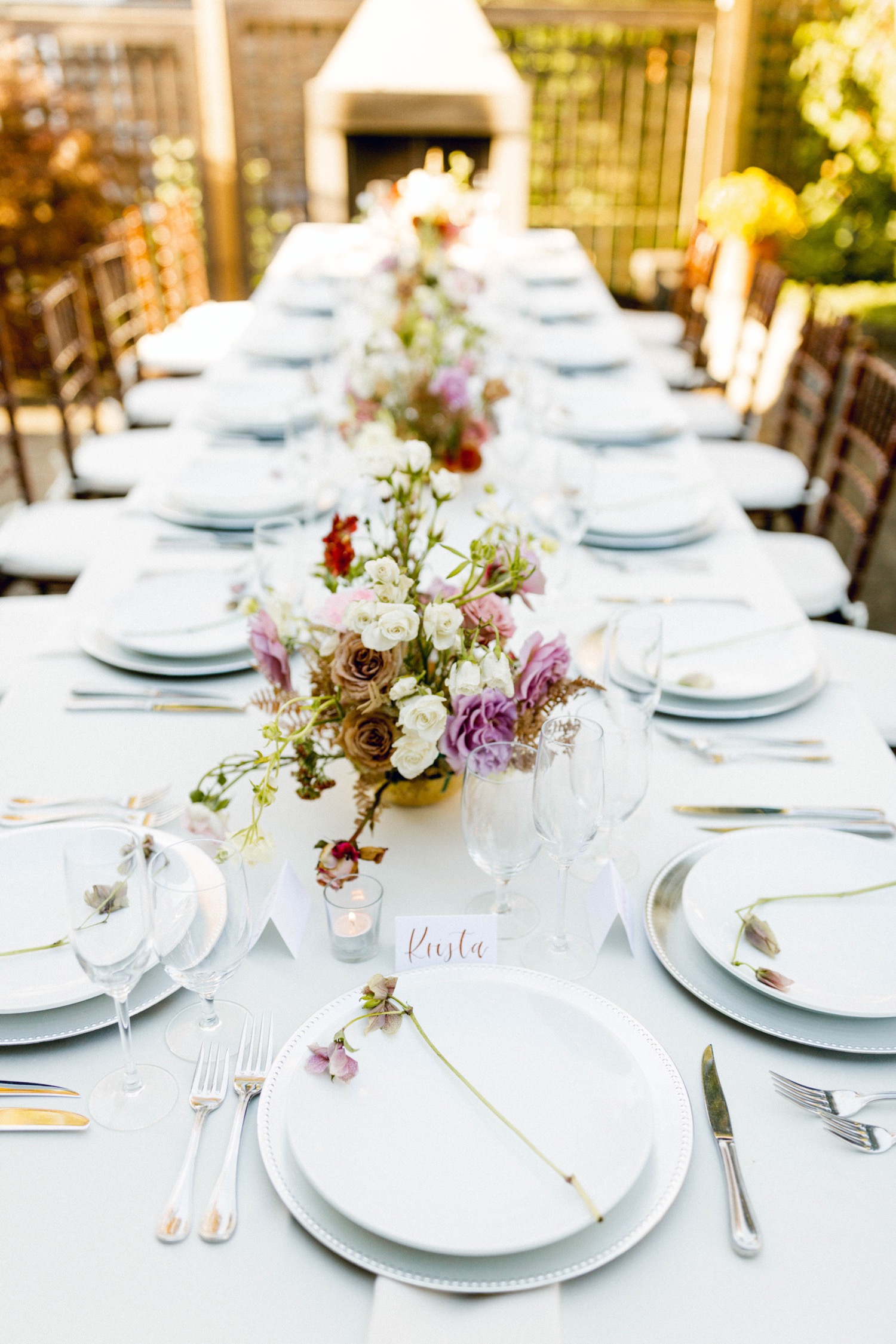 table setting with pink florals luxurious backyard wedding