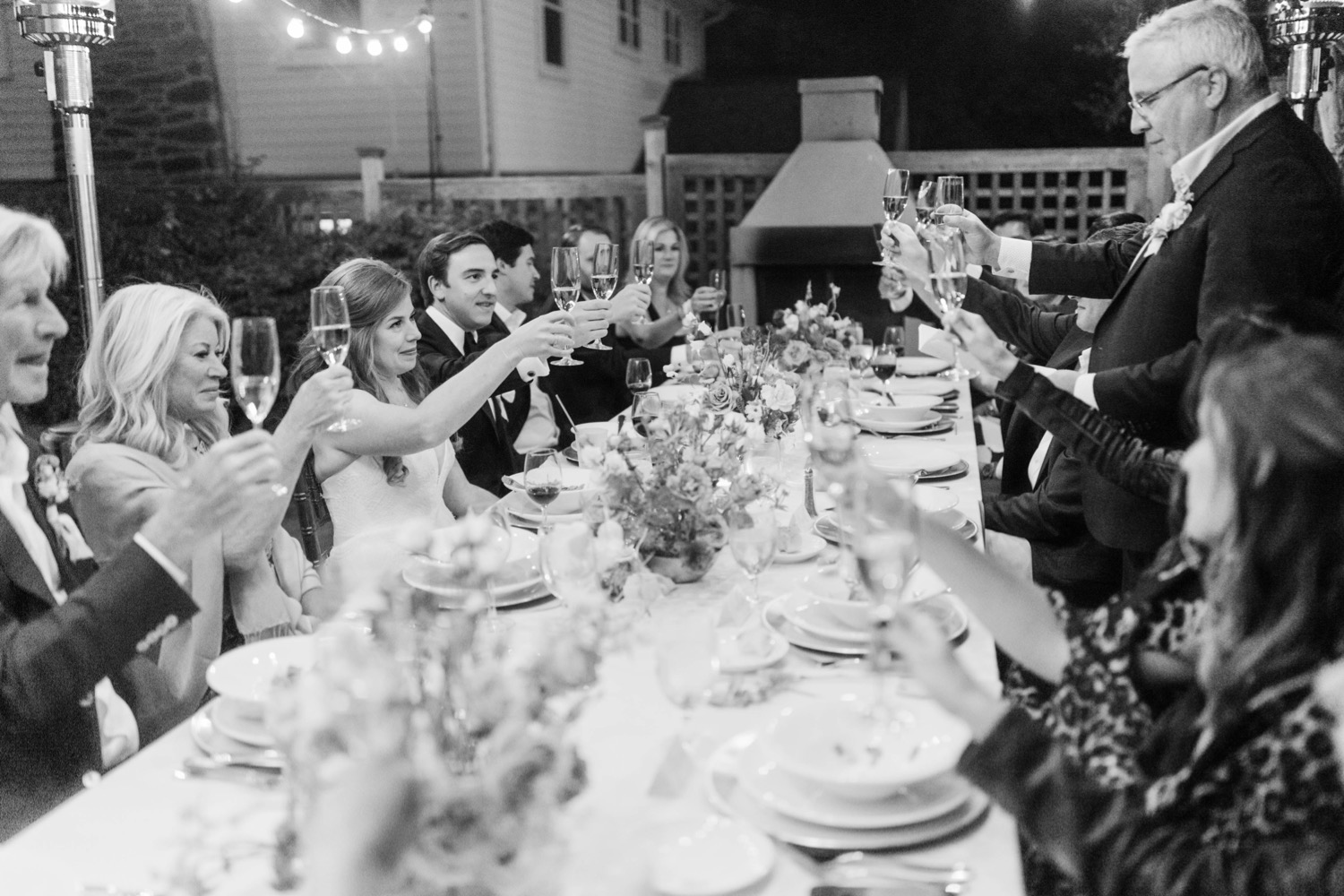 guests cheers toast at dinner wedding