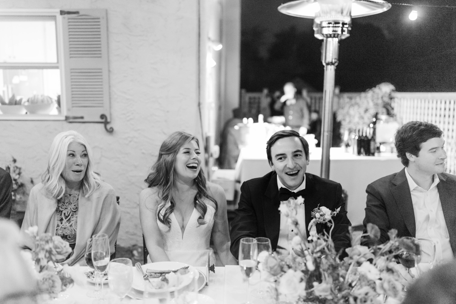 couple laughing during dinner luxurious backyard wedding