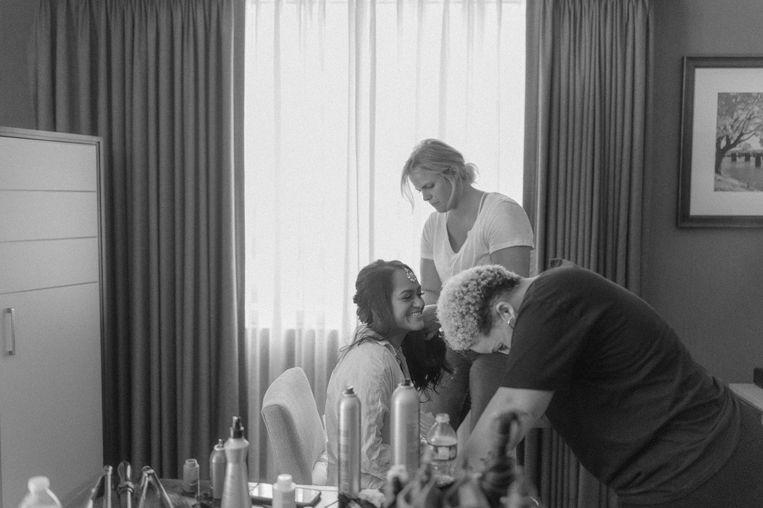 bride getting ready wedding hair makeup laughing