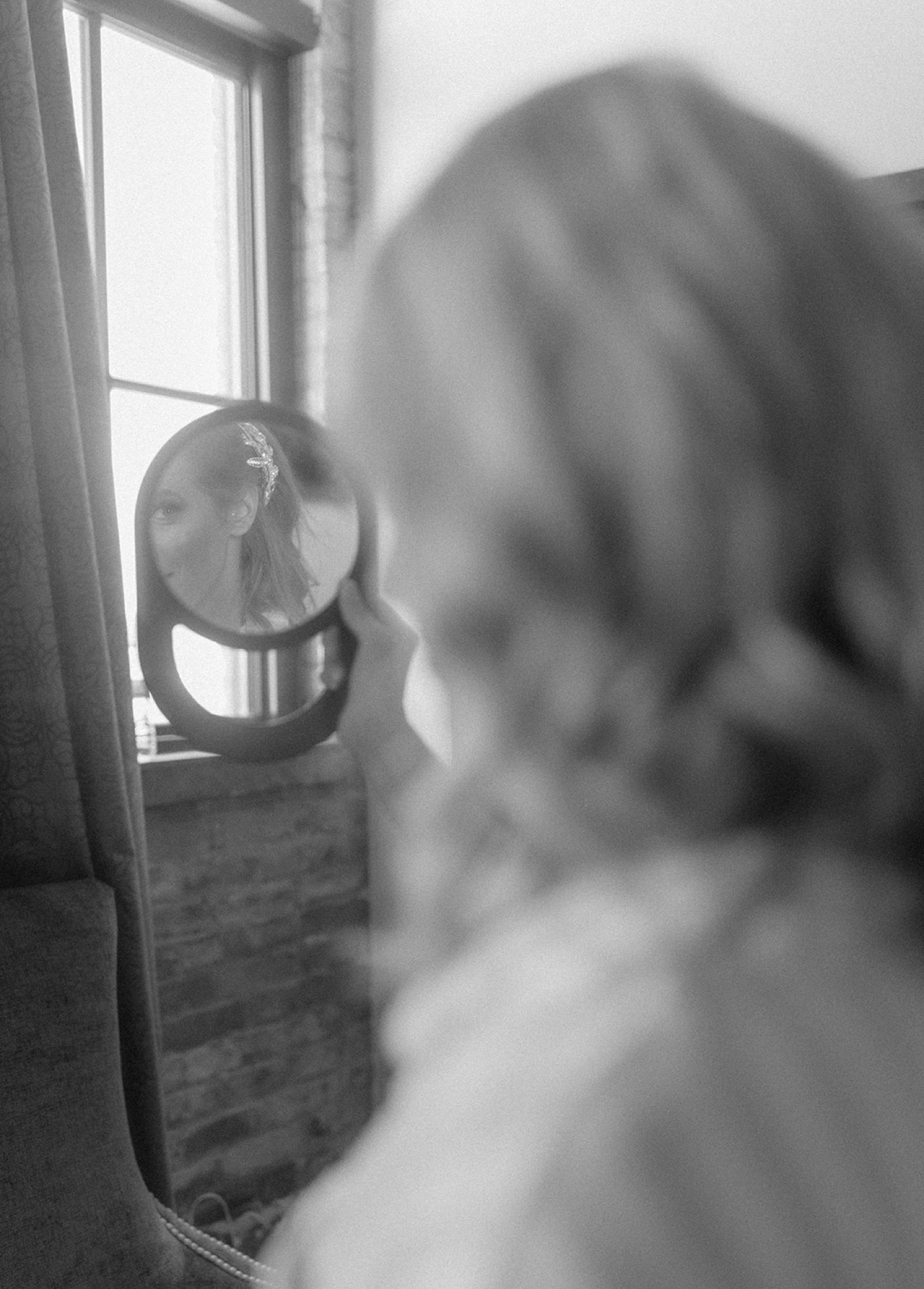 bride looking in mirror reflection