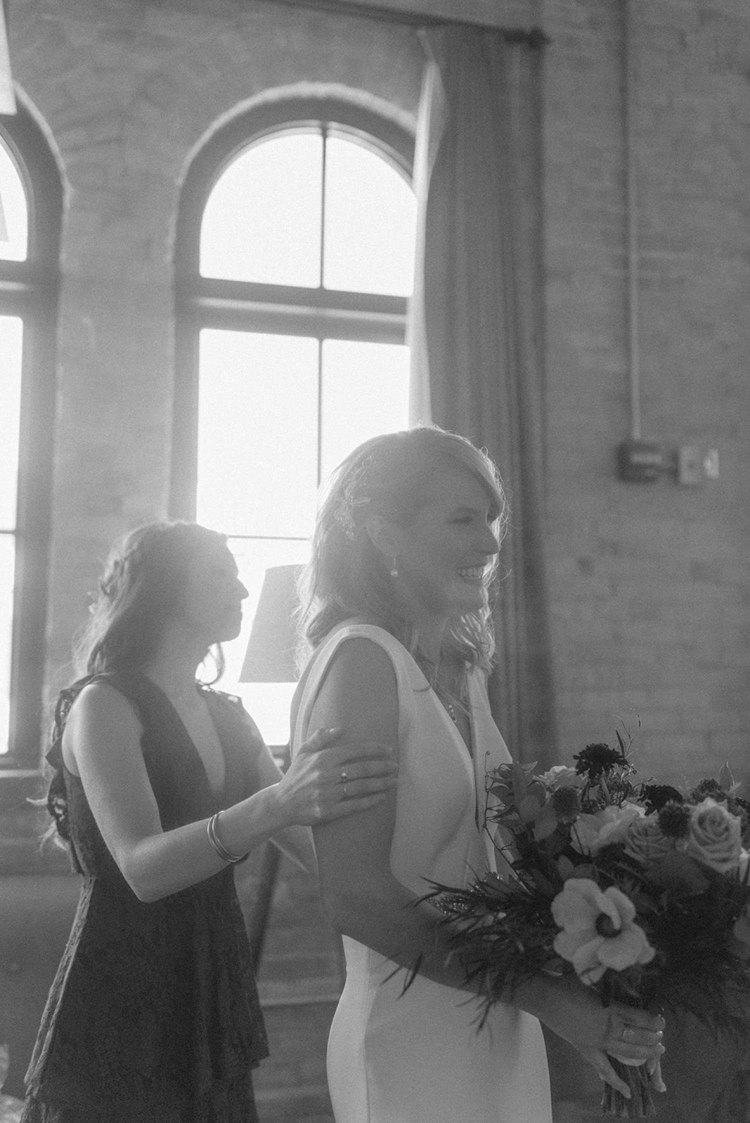 bride smiling sister holding shoulders