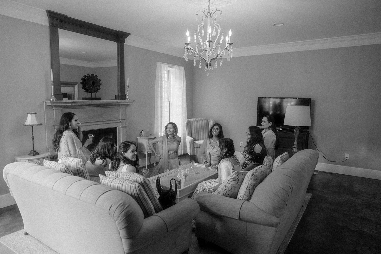 bride and bridesmaids sitting on couches