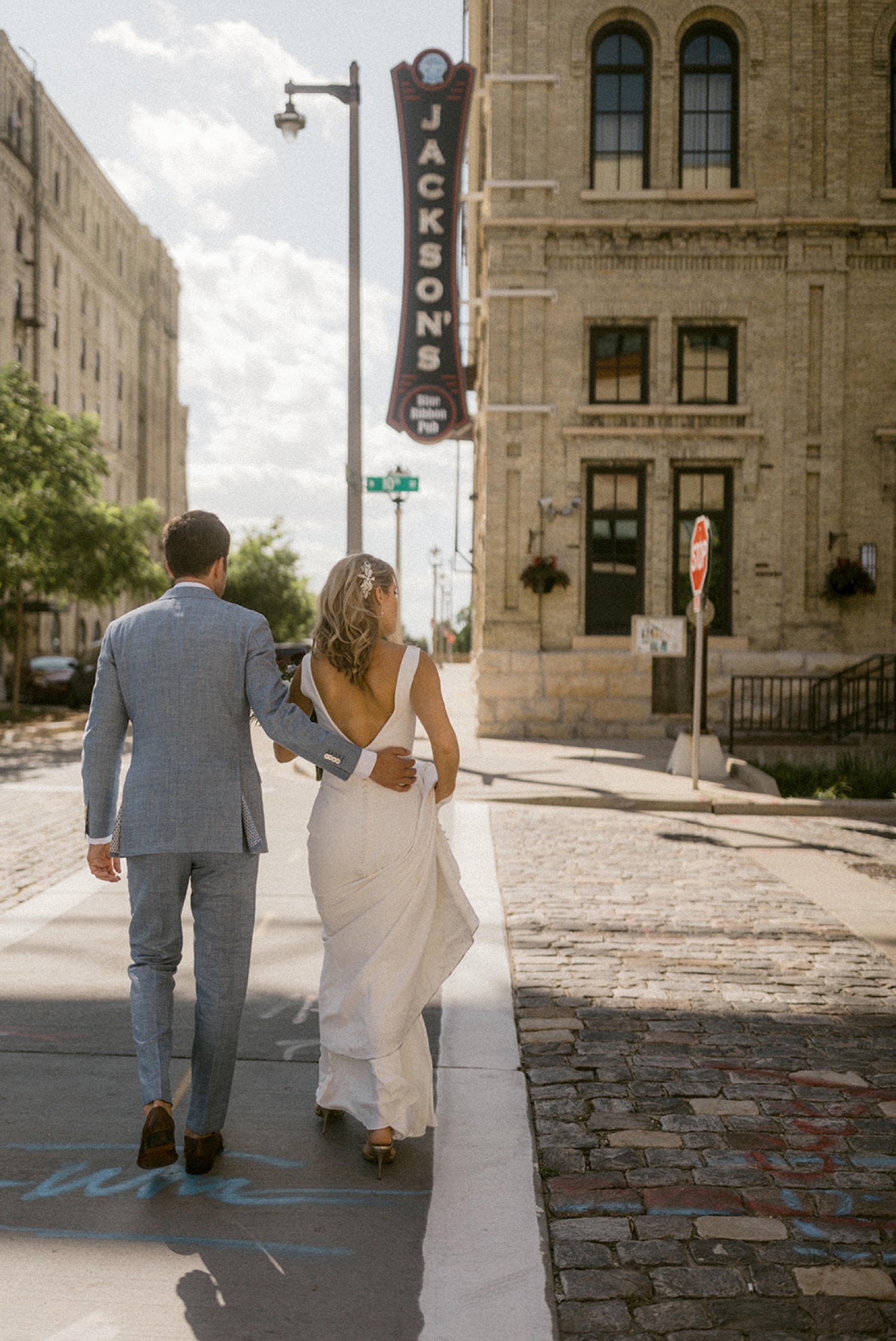 bride and groom walking downtown Milwaukee Jackson's Pabst Best Place Brewery Wedding