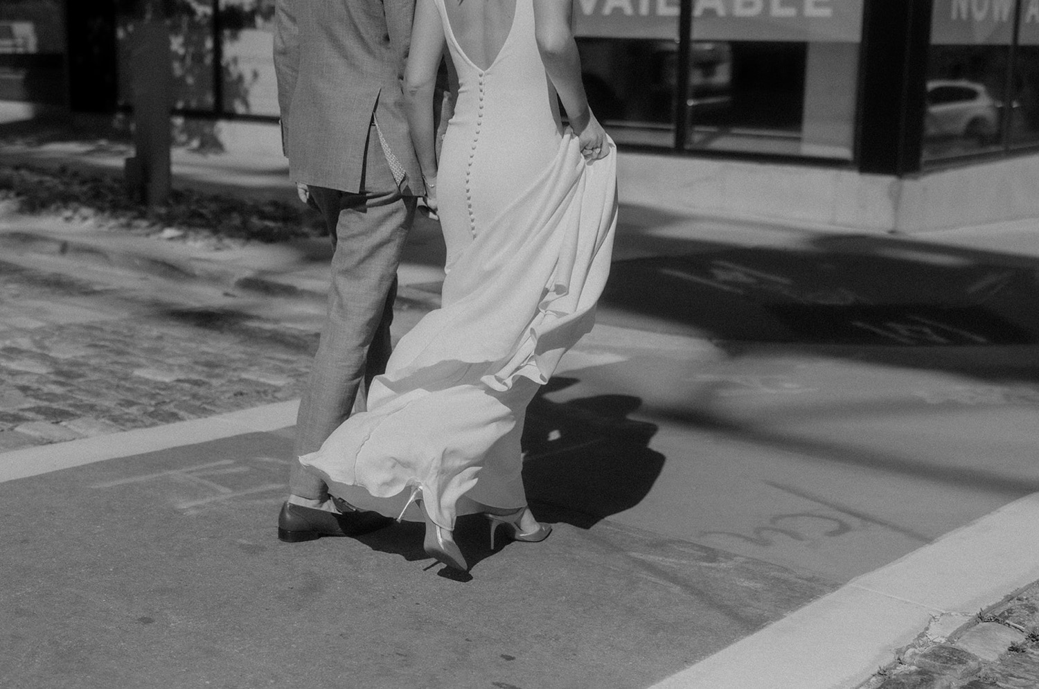 bride and groom walking in crosswalk