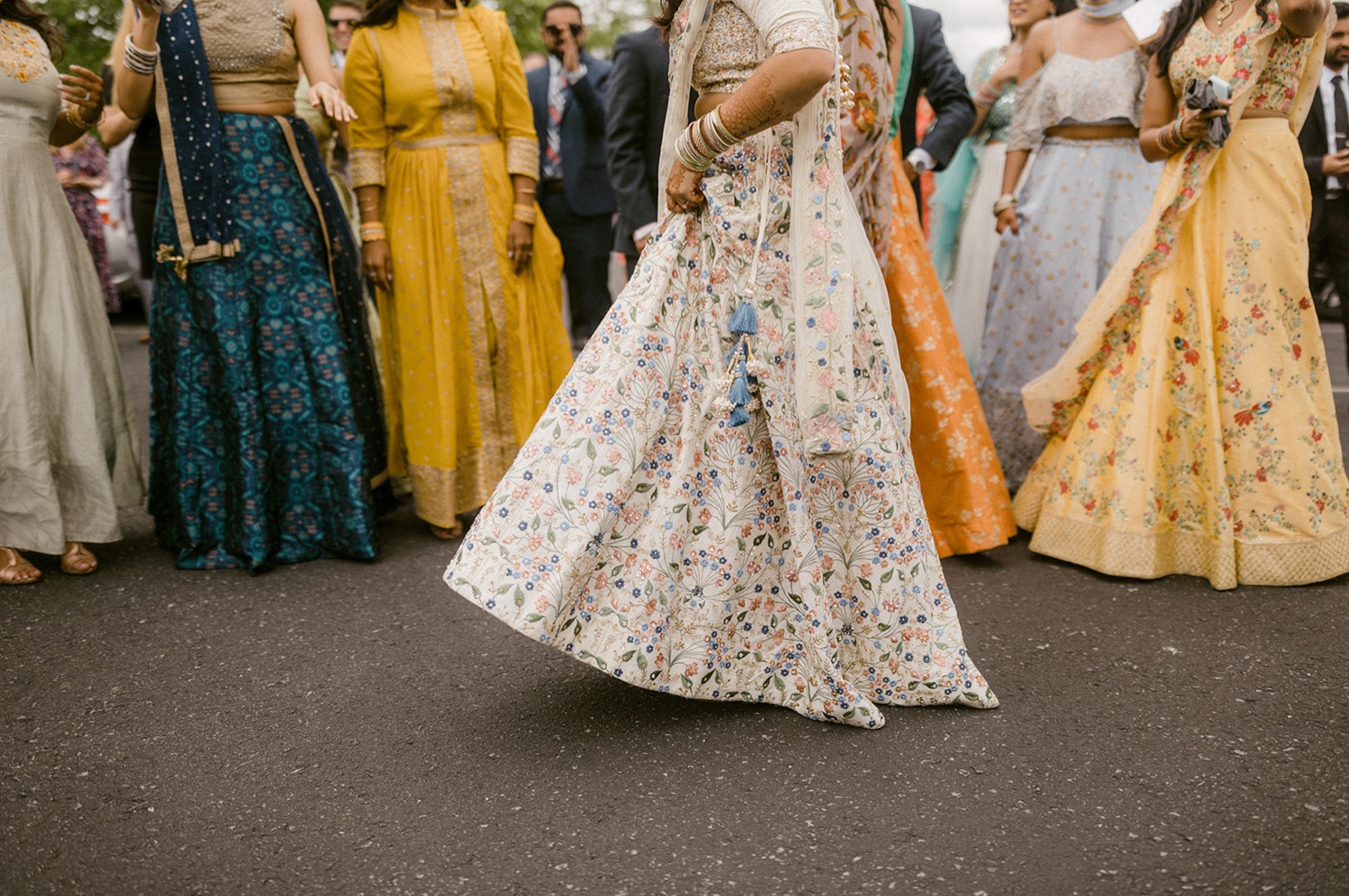 bride dancing in embroidered skirt wedding grooms parade