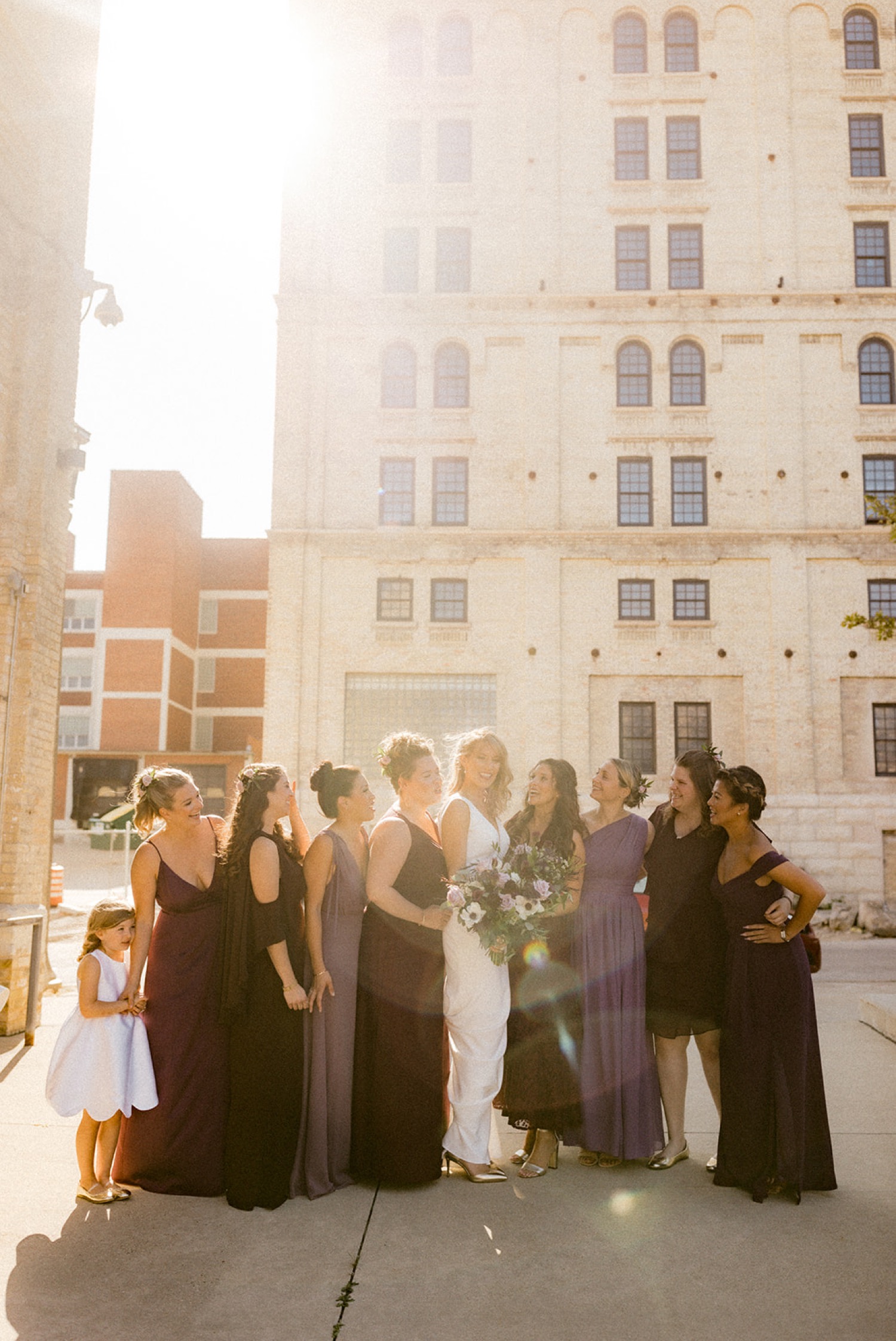 bride and bridesmaids wedding party rainbow reflection on camera lens