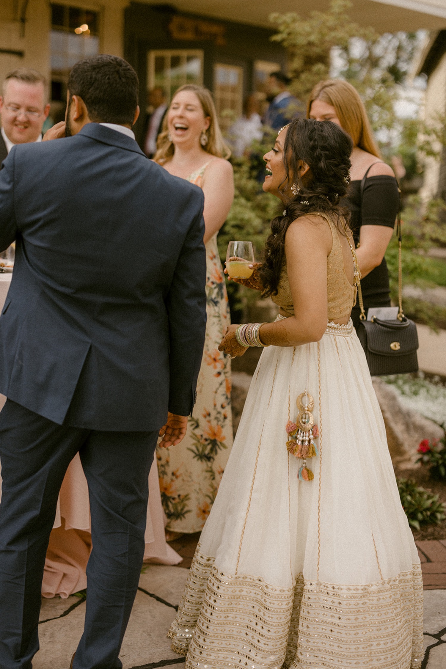 bride laughing at cocktail hour talking with guests
