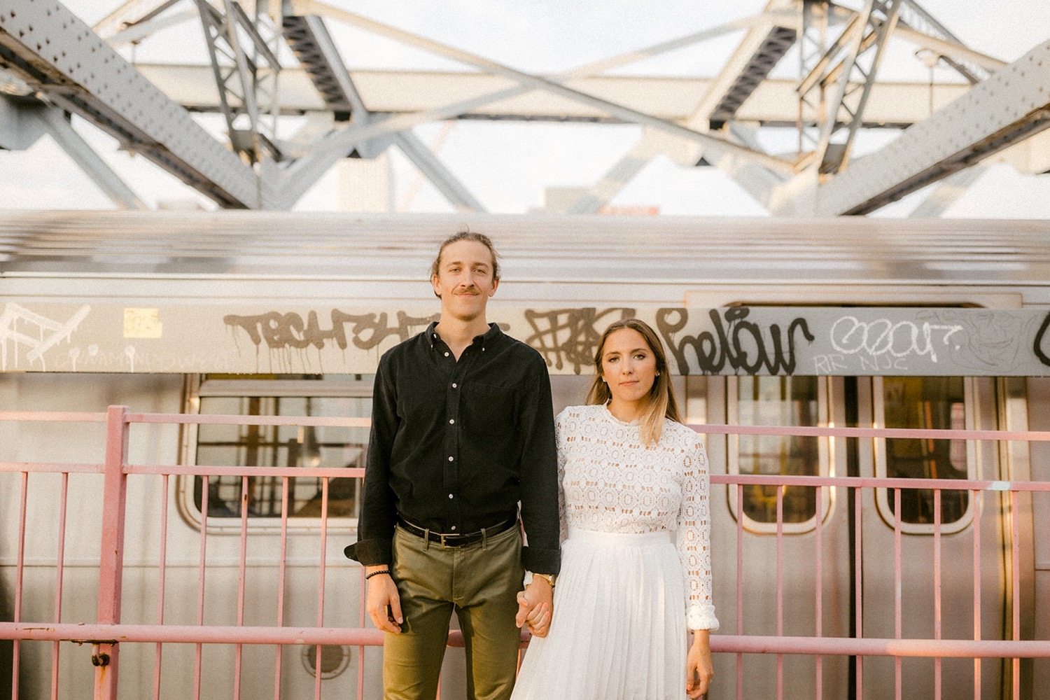 couple holding hands subway car brooklyn engagement session