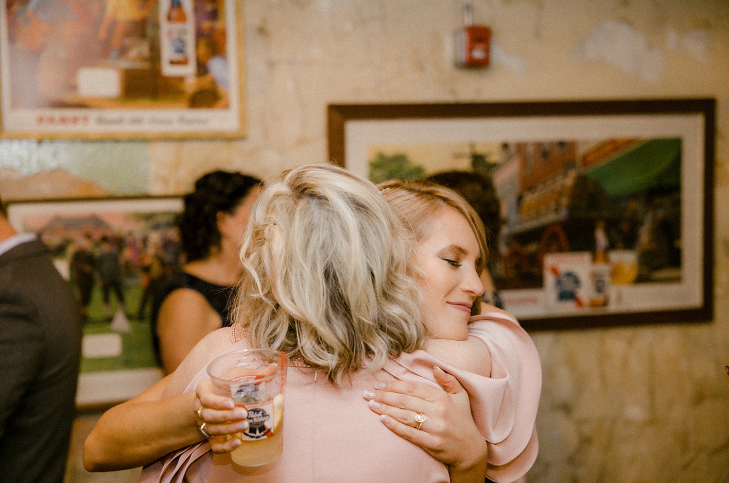 bride and mother hugging cocktail hour wedding