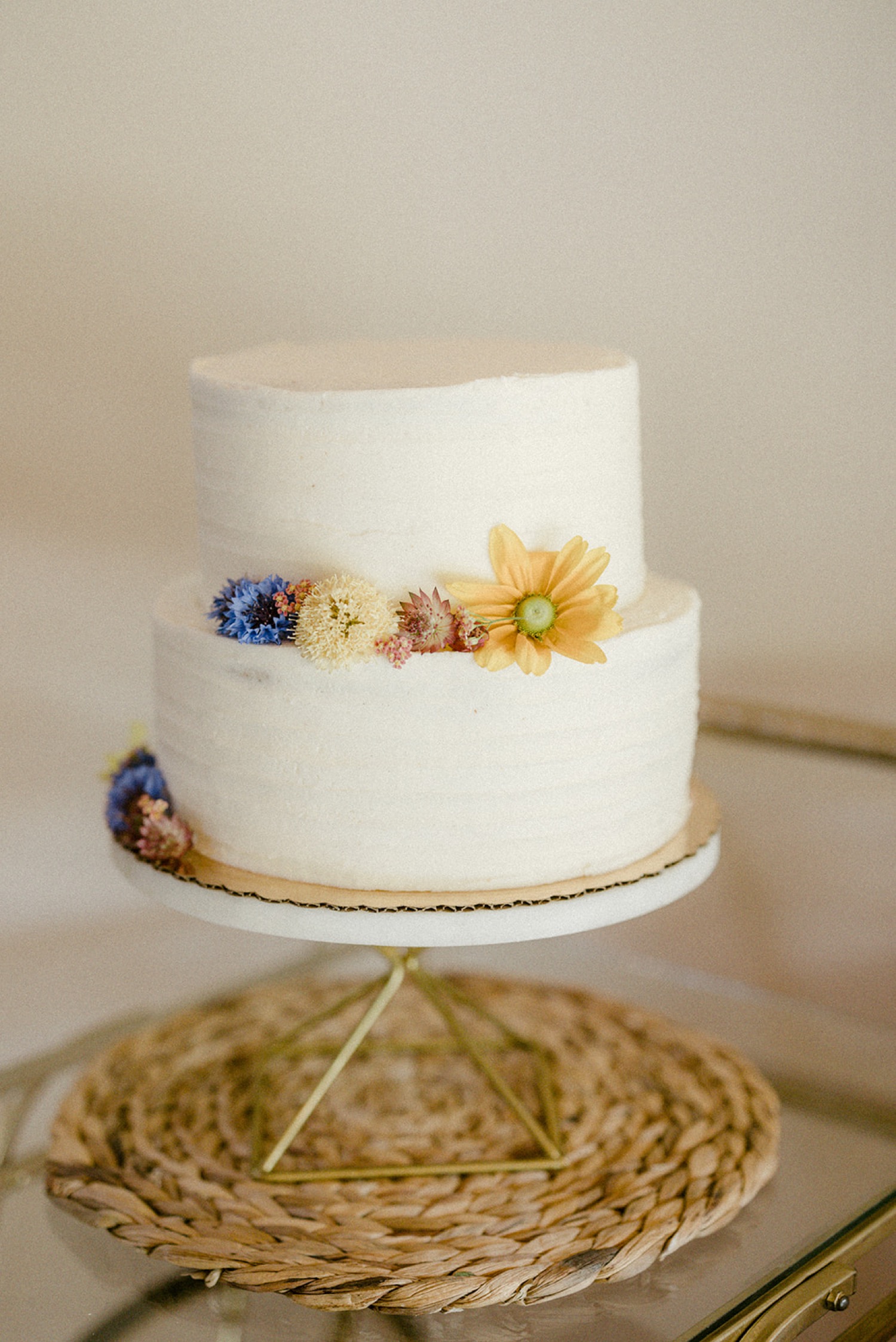 white two tiered wedding cake colorful flowers simple