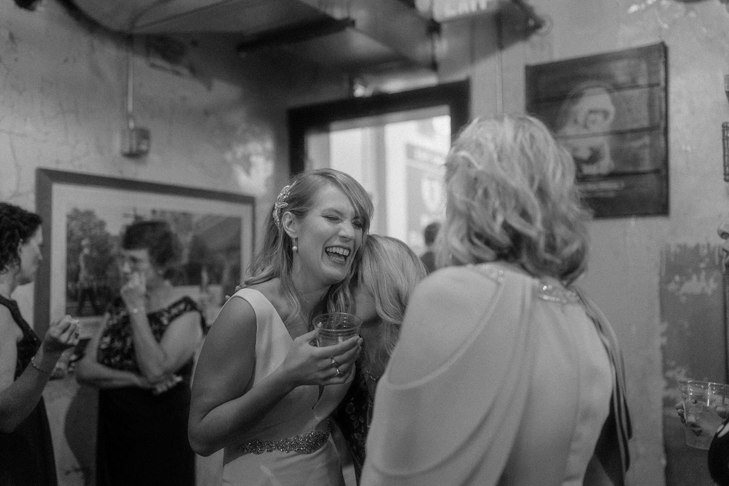 bride and mother in law laughing cocktail hour wedding