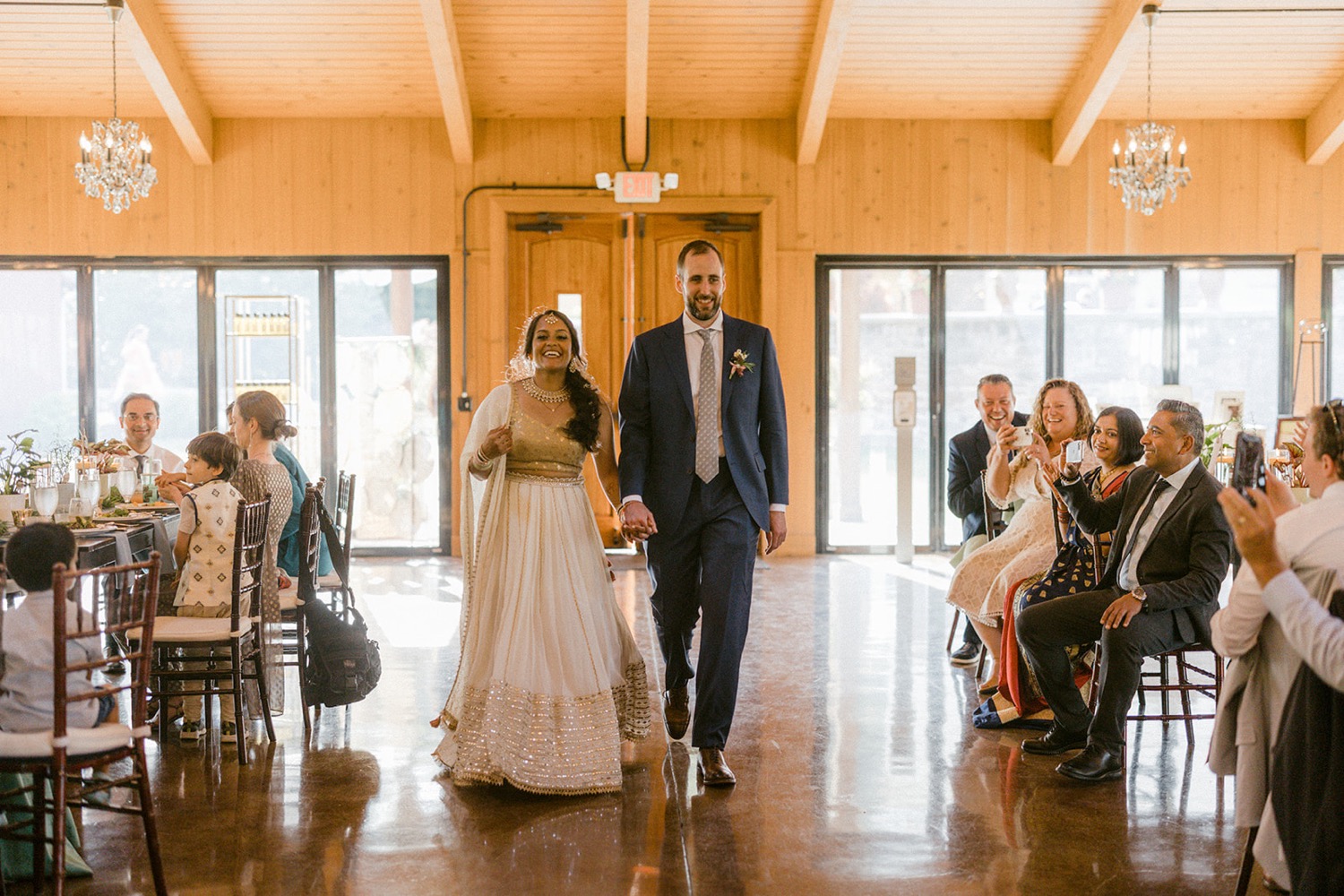 bride and groom walking into wedding reception