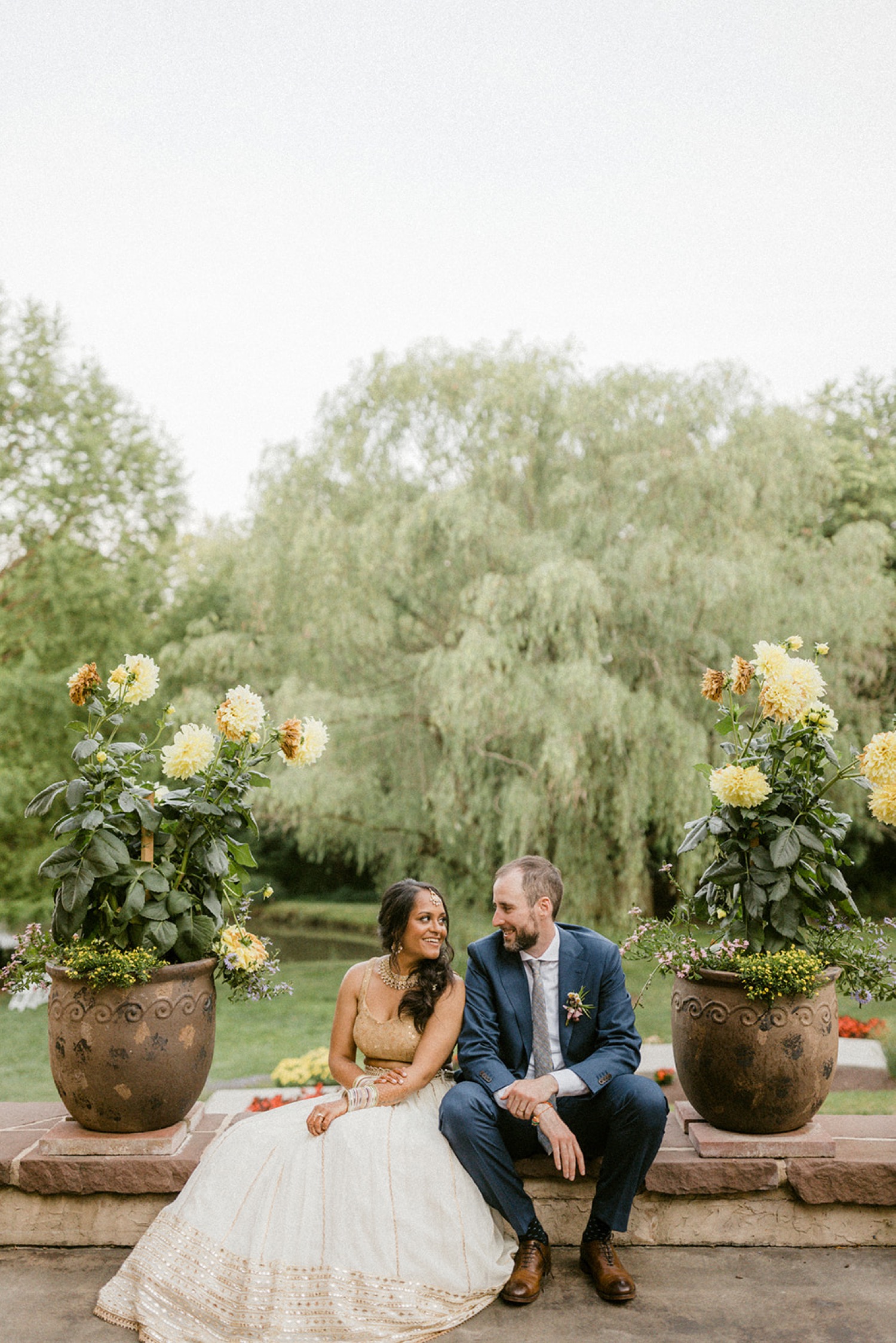bride and groom with potted plants Historic Acres of Hershey Wedding