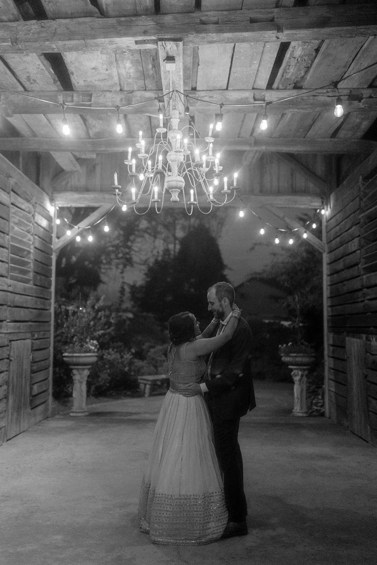 bride and groom slow dancing under chandelier Historic Acres of Hershey Wedding