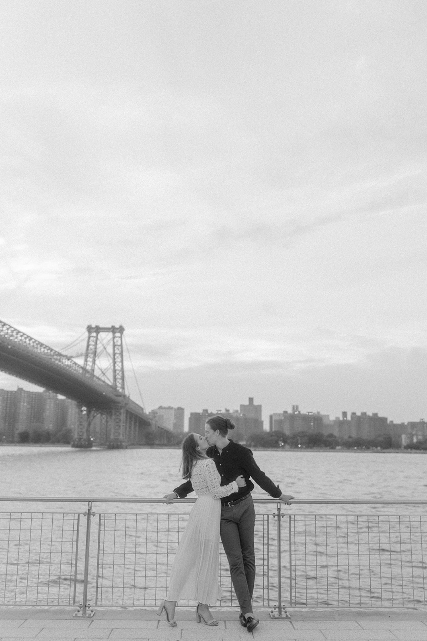 couple kissing on the water brooklyn engagement session