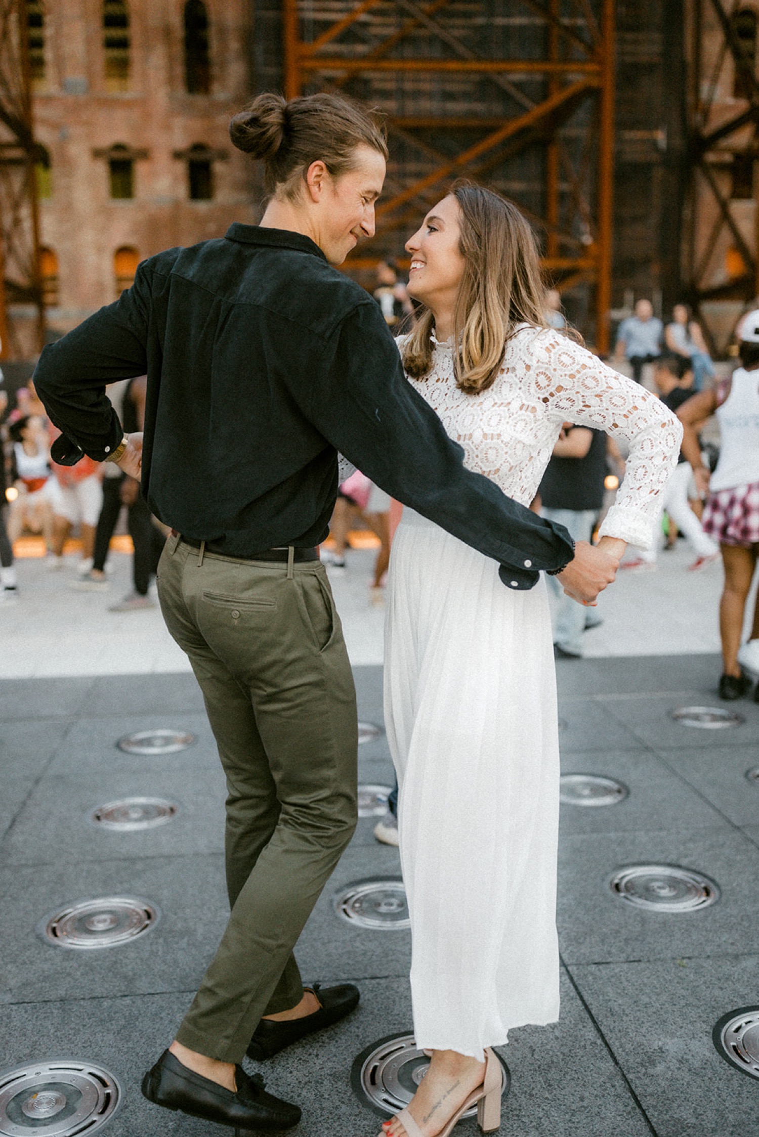 couple dancing in city square