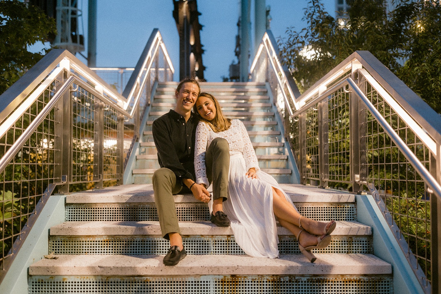 couple sitting on stairs at night brooklyn engagement session